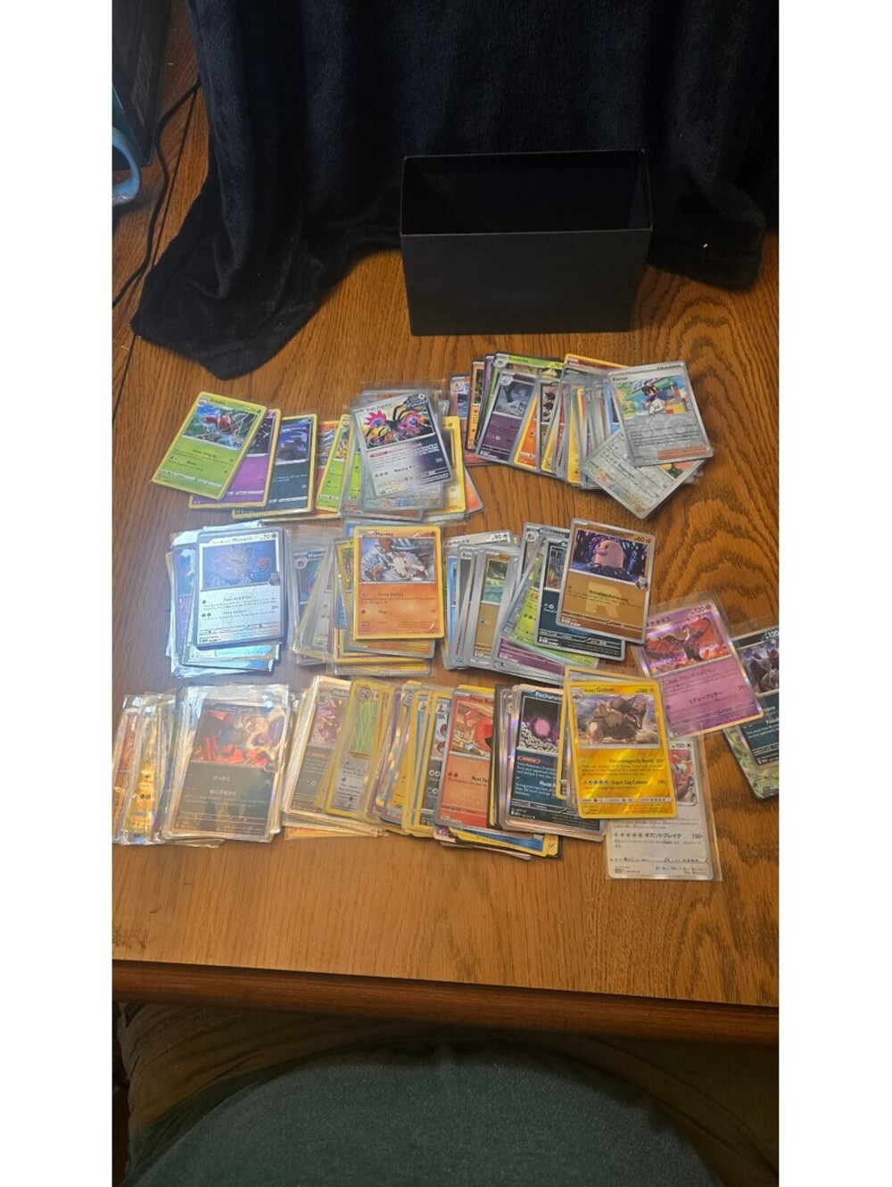Bulk Lot of Mixed Pokemon Trading Cards with Sleeves and Storage Box